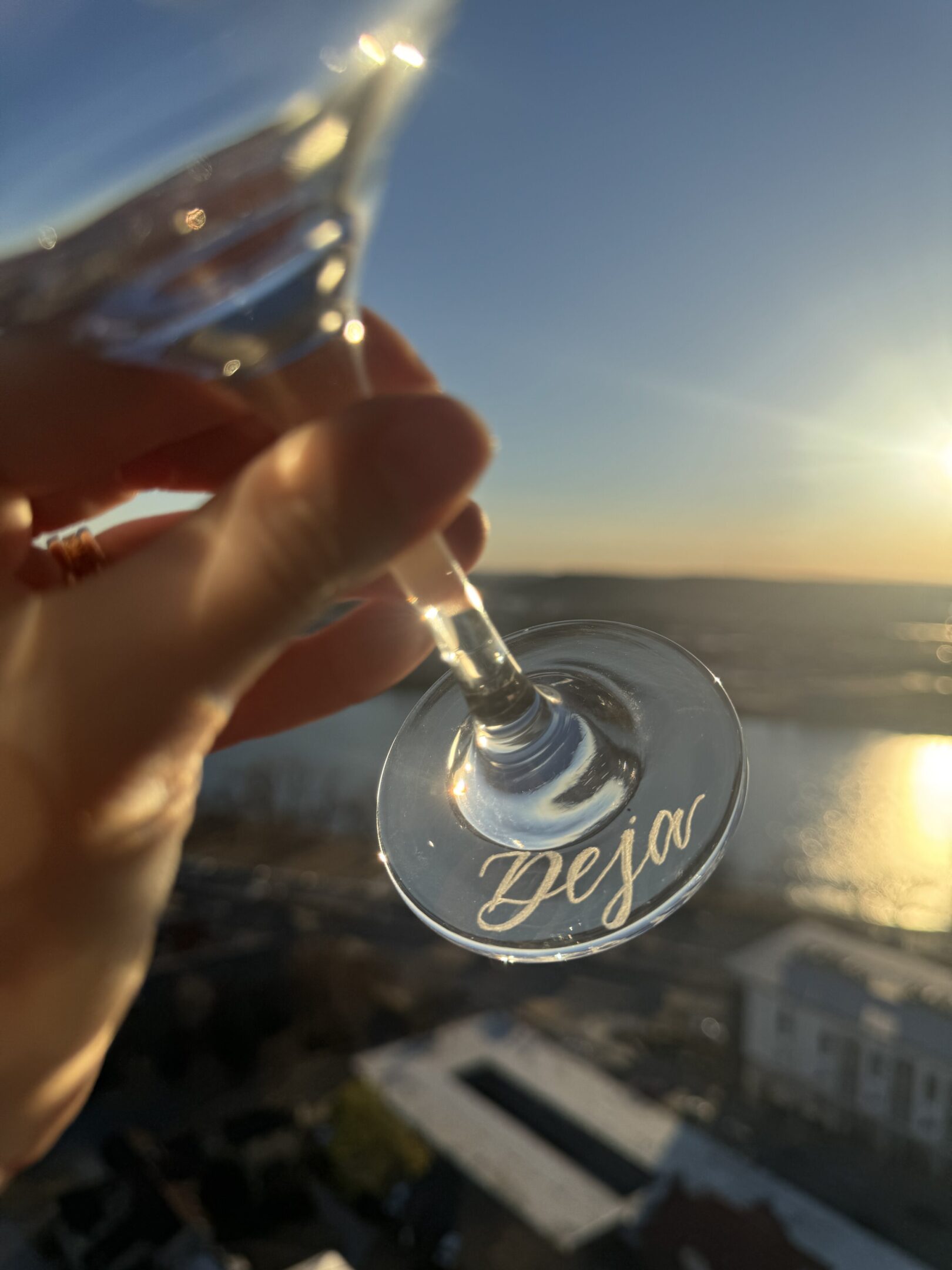 Martini glass with engraved name at sunset
