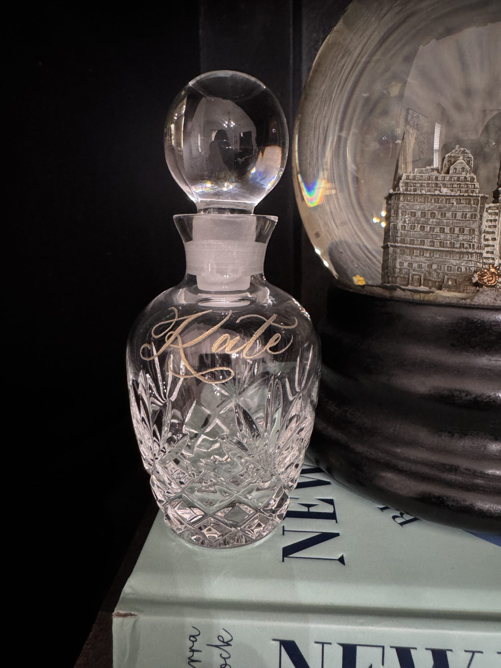 Elegant crystal decanter with intricate cut patterns and glass stopper.