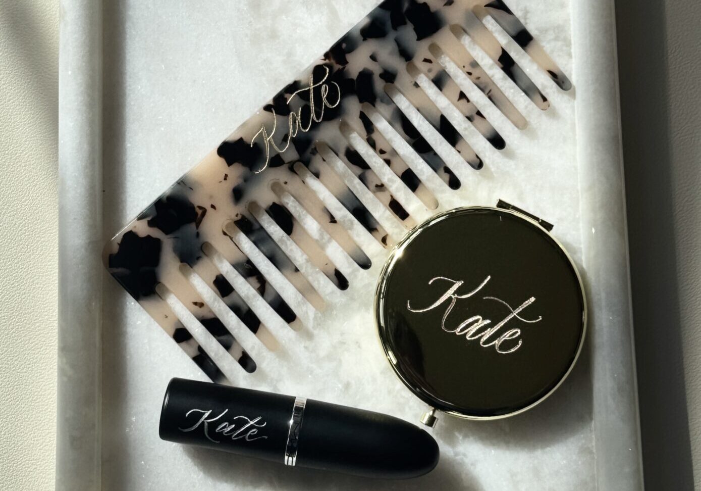 Makeup essentials including lipstick, powder, and a brush set.